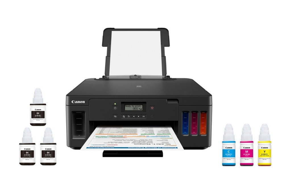 Black printer next to bottles of ink cartridge