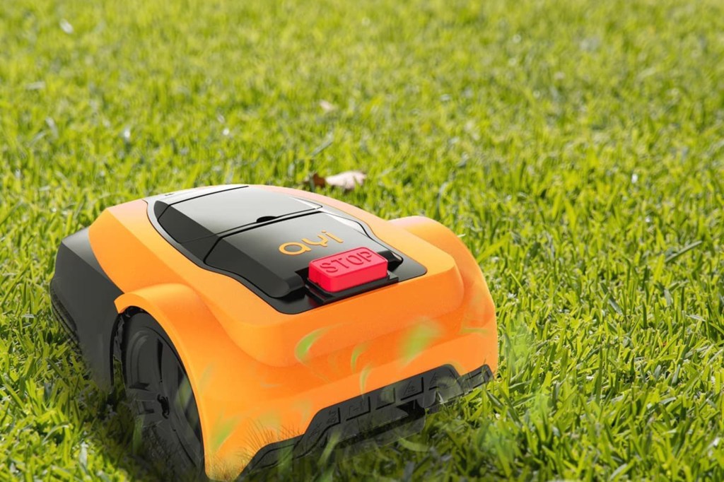 orange robot lawn mower on grass