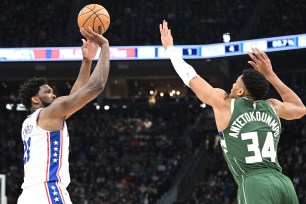 Joel Embiid, who hit a go-ahead 3-pointer with 41.4 seconds left, shoots over Giannis Antetokounmpo during the 76ers' 133-130 win.