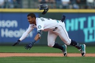 Mariners phemom Julio Rodriguez slides into a base.