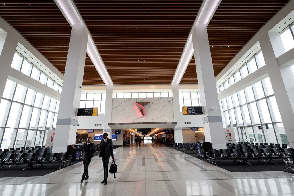 Two Delta Airlines employees walk through a gate area of the newly completed 1.3 million-square foot $4 billion Delta Airlines Terminal C at LaGuardia Airport in 2022.