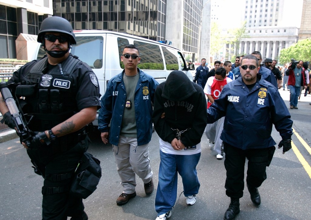 Special agents working for Immigration and Customs Enforcement (ICE) escort members of a Mexican gang to court following their arrests May 11, 2005 in New York City.