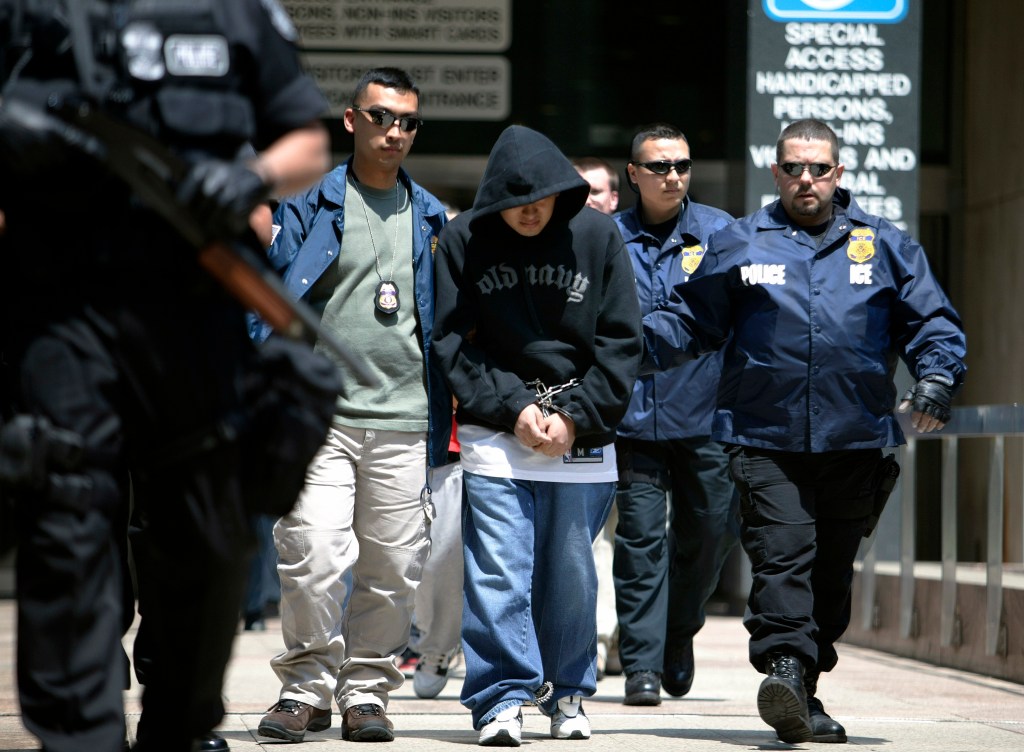 Special agents working for Immigration and Customs Enforcement (ICE) escort members of a Mexican gang to court following their arrests May 11, 2005.