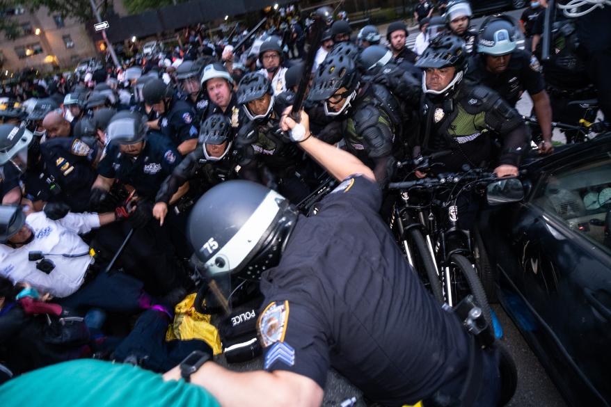 A police officer swinging a club at a protestor in the Bronx on June 4, 2020.