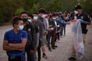 Unaccompanied minors from Central America line up to be transported by U.S. Customs Border Protection officials, after crossing the Rio Grande river into the United States from Mexico on rafts in Penitas, Texas, U.S., March 26, 2021.