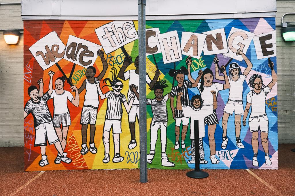 A mural at Success Academy Harlem 2 reads "We Are The Change"