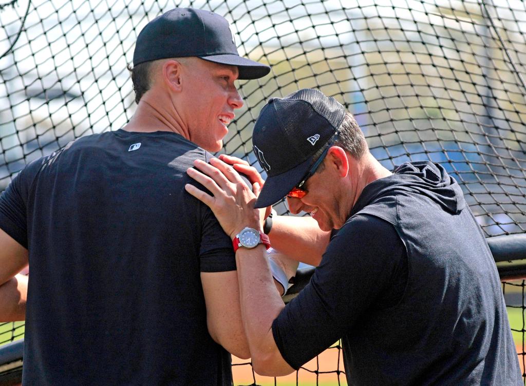Aaron Boone, right, laughs with Aaron Judge at Yankees spring training.