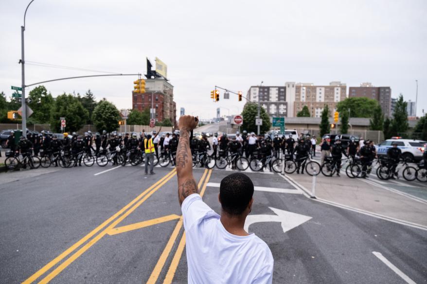 A man raising his fist at police officers during before the clash.