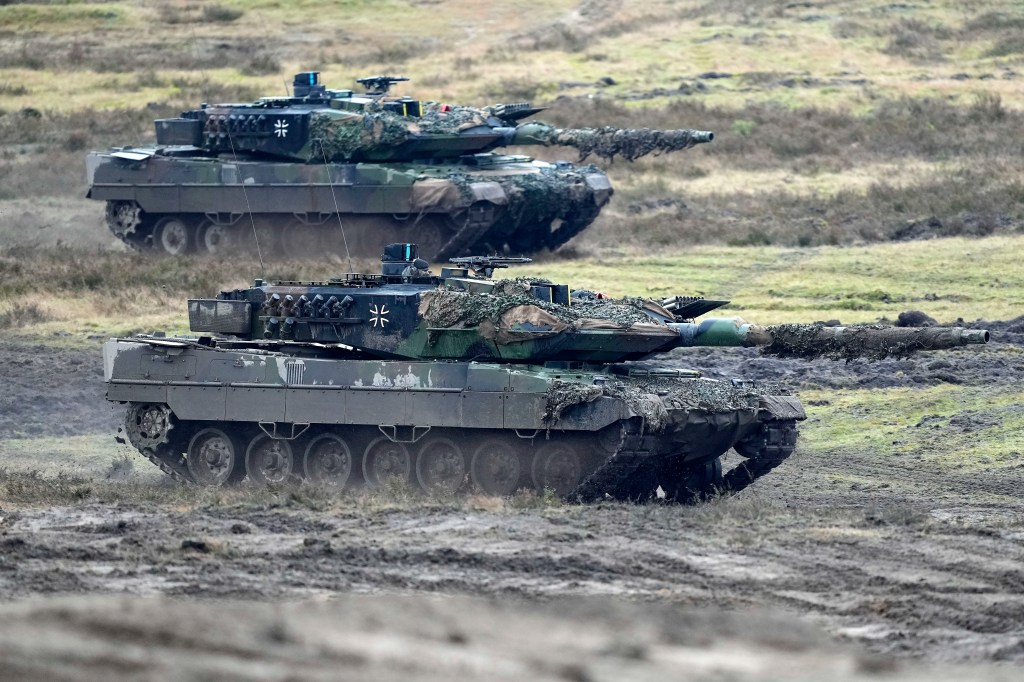 Two Leopard 2 tanks are seen in action at the Field Marshal Rommel Barracks in Augustdorf, Germany, Wednesday, Feb. 1, 2023.  