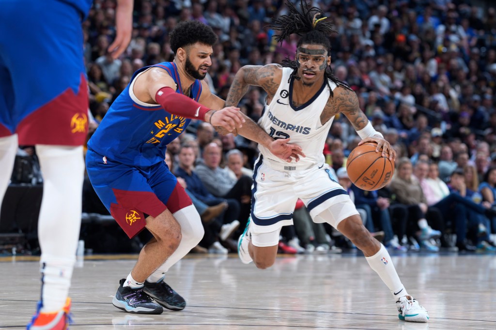 Memphis Grizzlies guard Ja Morant, drives against Denver Nuggets guard Jamal Murray.