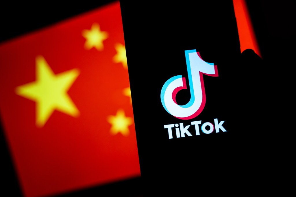 TikTok logo displayed on a mobile phone screen in front of the China flag is seen in this illustration photo.