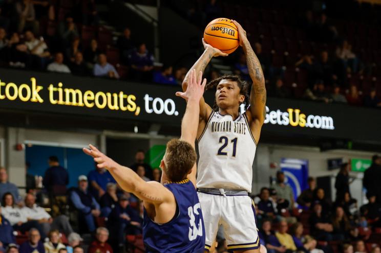 Montana State guard RaeQuan Battle (21 puts up a shot over Northern Arizona forward Carson Towt (33) in the first half of an NCAA college basketball game for the championship of the Big Sky men's tournament in Boise, Idaho, Wednesday, March 8, 2023.