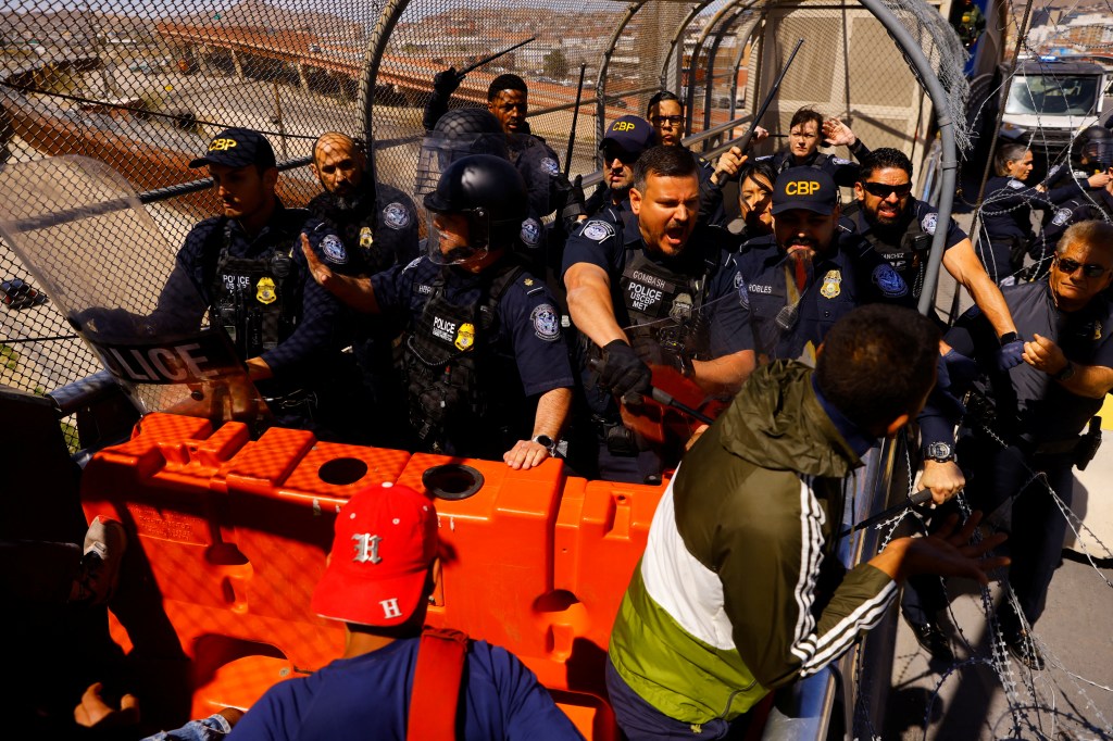 U.S. Customs and Border Protection agents confront migrants