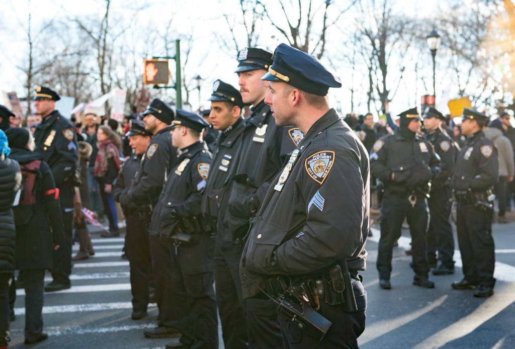 NYPD officers are seen during a rally to protest the executive order that President Donald Trump signed clamping down on refugee admissions.