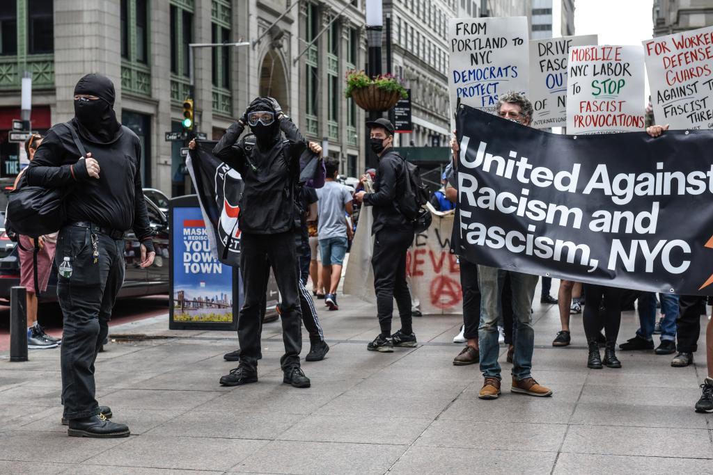 Left wing protesters, some affiliated with Antifa, hold a counter protest against right wing protesters.