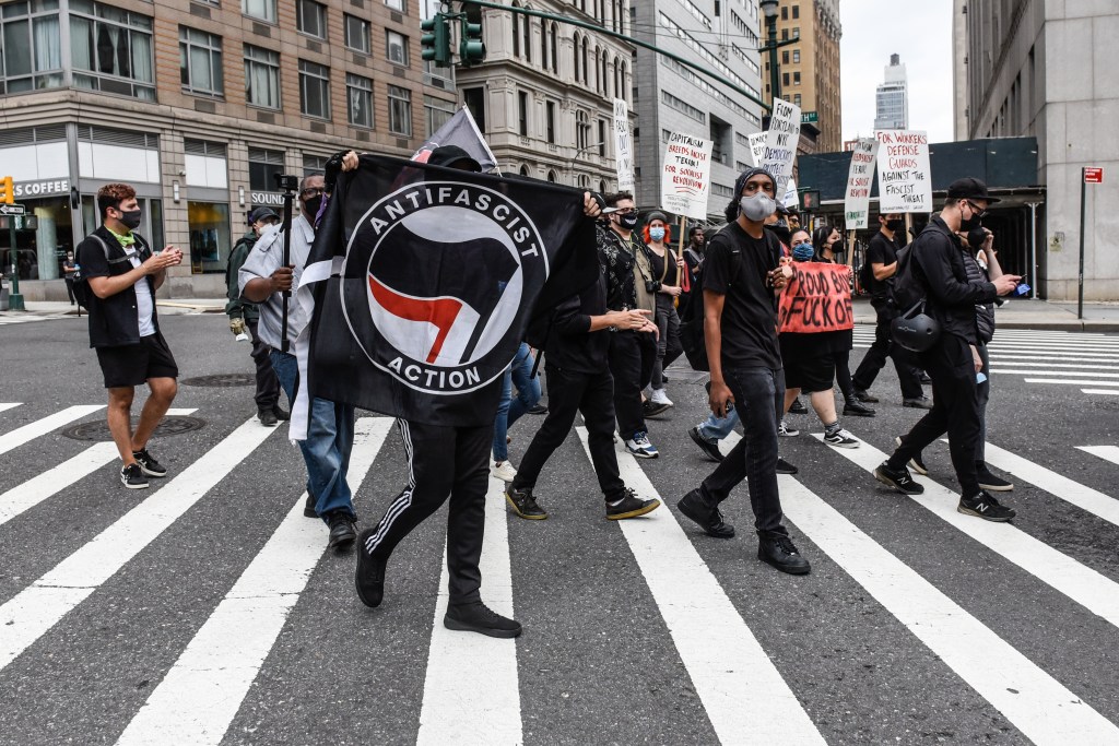 Left wing protesters, some affiliated with Antifa, hold a counter protest against right wing protesters participating in a political rally on July 25, 2021 in New York City.