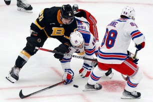 Patrick Kane (88) and Vincent Trochek battle Dmitry Orlov for the puck during the Rangers' 4-2 loss to the Bruins.