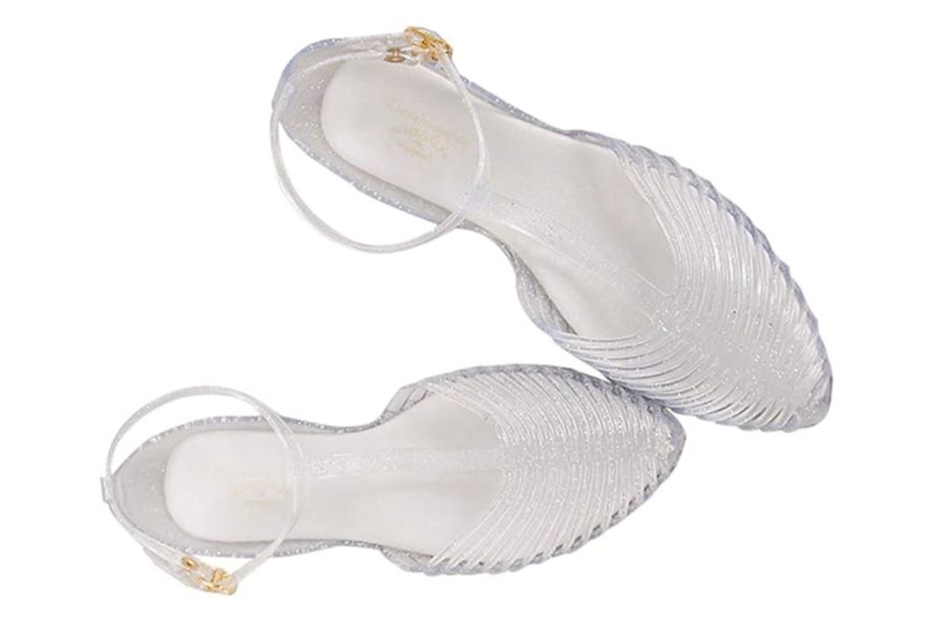 A pair of clear glittery jelly sandals, photographed from above.