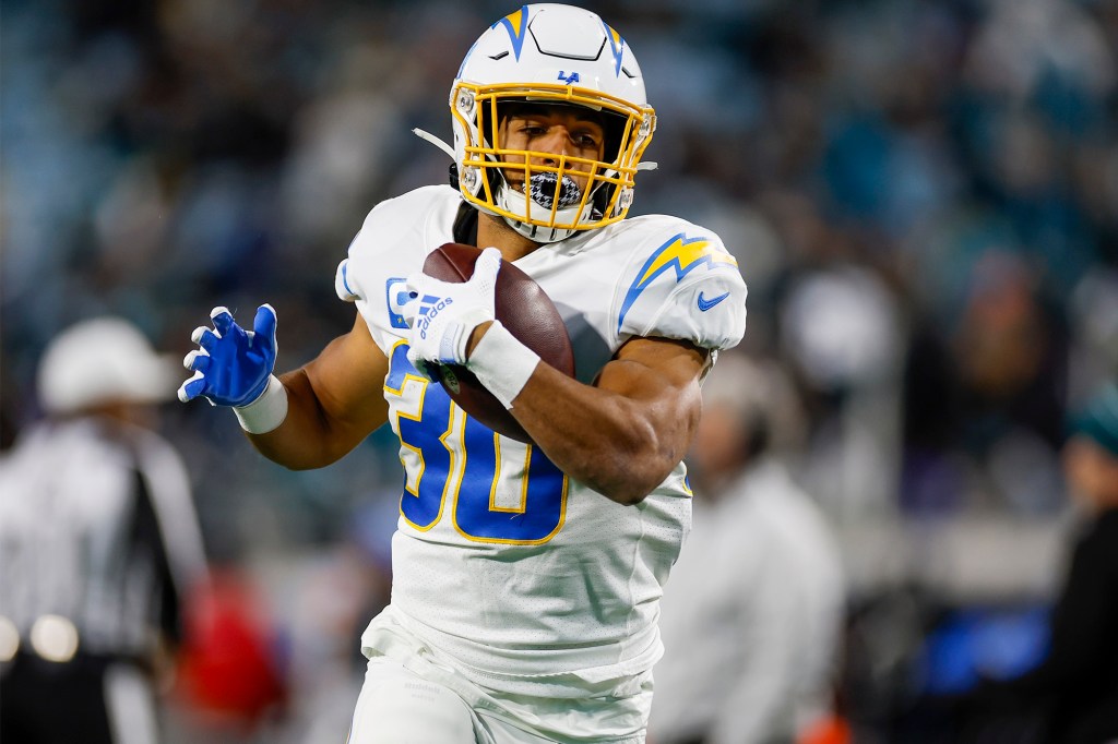 Running back Austin Ekeler runs with the ball during a playoff game against the Jaguars in January 2023.