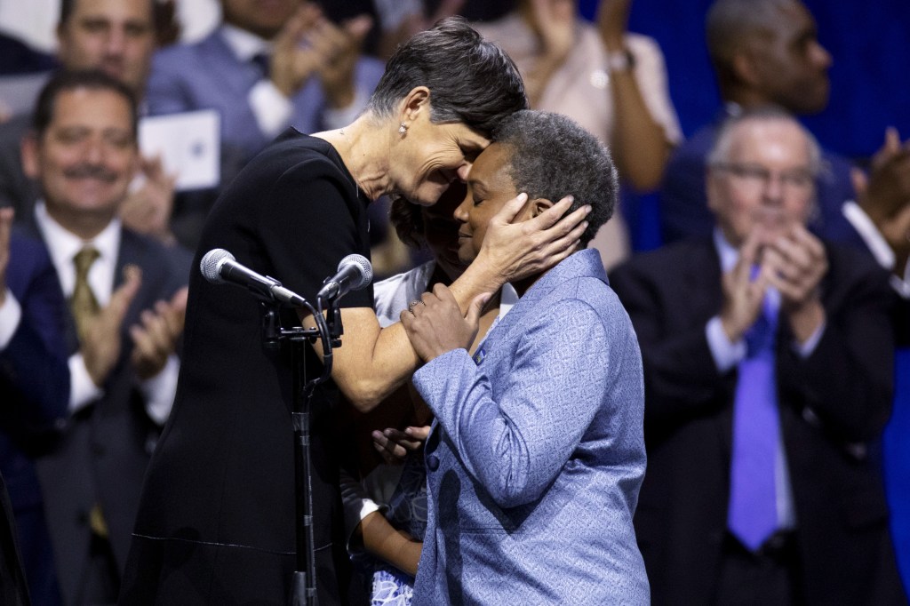 Lori Lightfoot, mayor of Chicago, right, embraces her wife Amy Eshleman after taking the oath of office during an inauguration ceremony in Chicago, Illinois, U.S., on Monday, May 20, 2019.