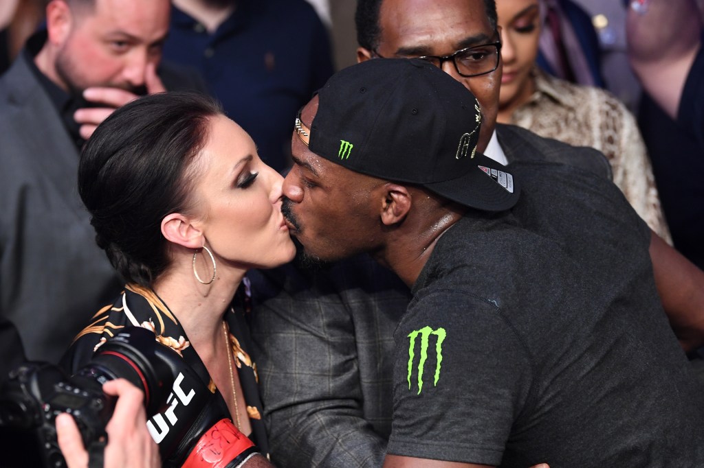 Jon Jones shares a kiss with his fiancee, Jessie Moses following his UFC light heavyweight championship bout during the UFC 235 event at T-Mobile Arena on March 2, 2019