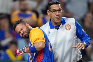 Venezuela's Jose Altuve is helped up by a trainer after he was hit by a pitch during the fifth inning of a World Baseball Classic game against the U.S., Saturday, March 18, 2023, in Miami. (AP Photo/Wilfredo Lee)