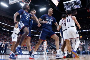 Jordan Hawkins, who scored a game-high 20 points, celebrates with teammates after making a basket during UConn's 82-54 blowout win over Gonzaga to reach the Final Four.