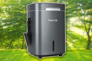 Composter on the background of a green, leafy lawn.