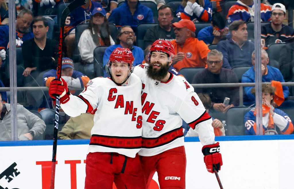 Jesper Fast (71) and Brent Burns celebrate during the Hurricanes' loss to the Islanders on April 21.