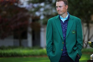 2015 Masters champion Jordan Spieth sports his green jacket.