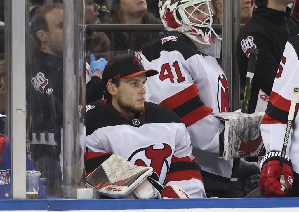 Devils goalie Akira Schmid sits on the bench after getting pulled in the third period of the Rangers' Game 6 victory.