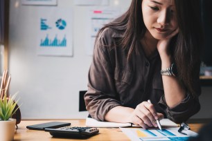 A young woman considering how personal loans can affect her taxes.