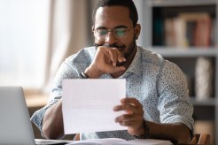 A man smiles at his personal loan.