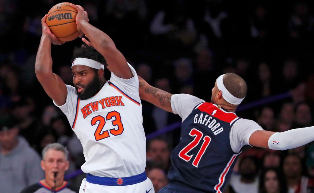 Mitchell Robinson pulls a down a rebound away from the Wizards' Daniel Gafford during a recent game.