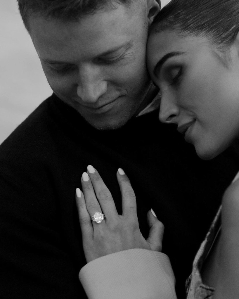Christian McCaffrey and Olivia Culpo, with the oval cut ring with the "Whisper Thin® with Epaulette Side Stones."