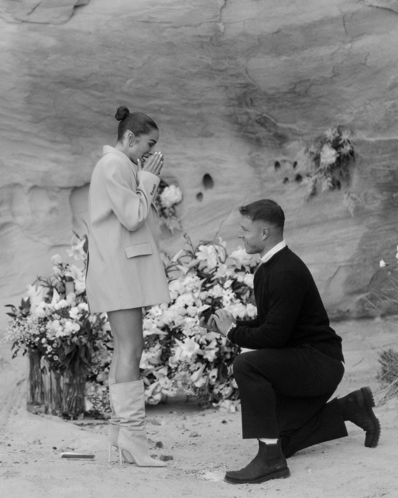Christian McCaffrey kneels down to propose to girlfriend Olivia Culpo. 
