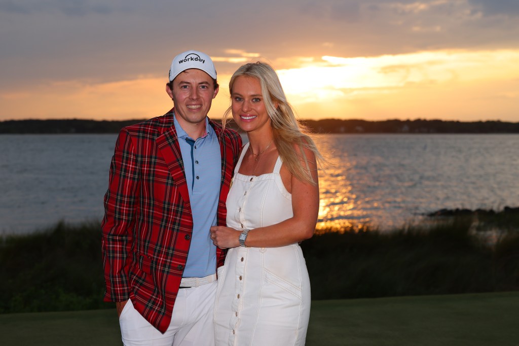 Matt Fitzpatrick of England celebrates in the Heritage Plaid tartan jacket alongside girlfriend Katherine Gaal after winning the RBC Heritage at Harbour Town Golf Links on April 16, 2023 in Hilton Head Island, South Carolina.  