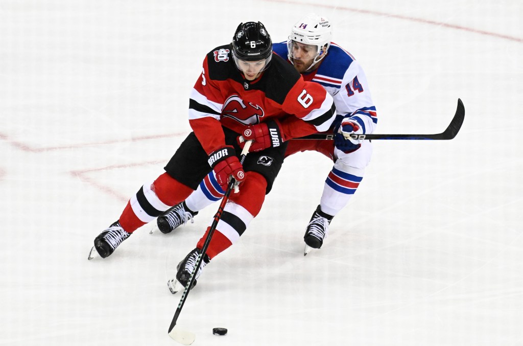 Tyler Motte checks John Marino during the Rangers' 5-1 Game 1 win over the Devils.