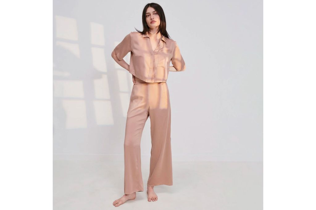 Woman in pink silk pajamas.