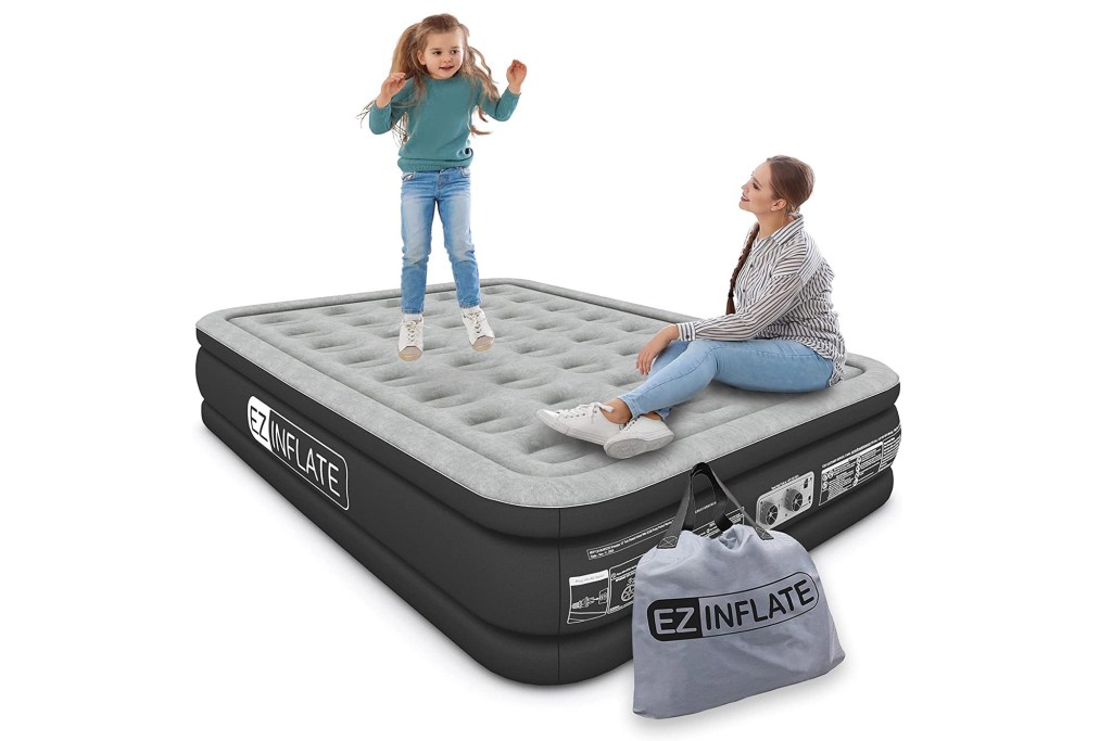 models on top of gray inflatable mattress