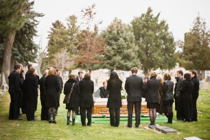 People outside a funeral service.