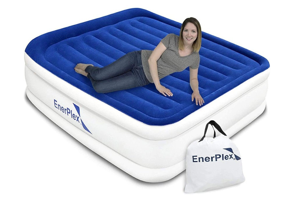 model laying on blue and white air mattress