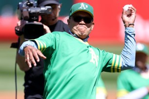 Reggie Jackson throws out the ceremonial first pitch during a ceremony honoring the 50-year reunion of the World Series Champions 1973 Oakland Athletics