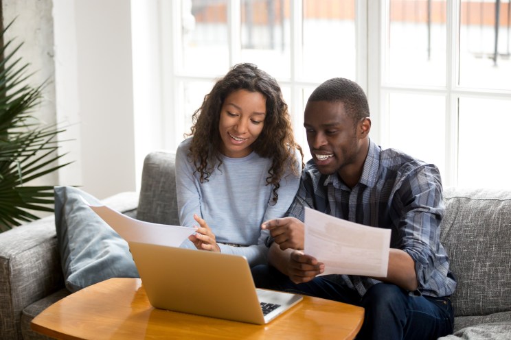 Couple smiles as they are approved for a mortgage