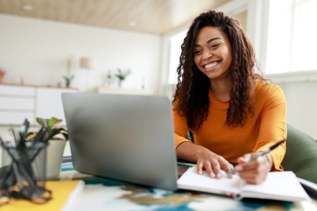 Woman smiles after finding a private student loan lender