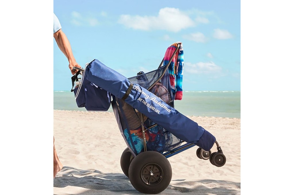 A person pushing a beach cart