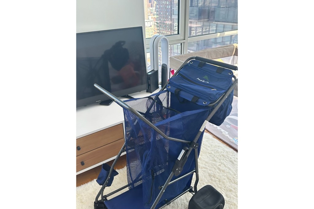 A blue cart positioned in front of a television.