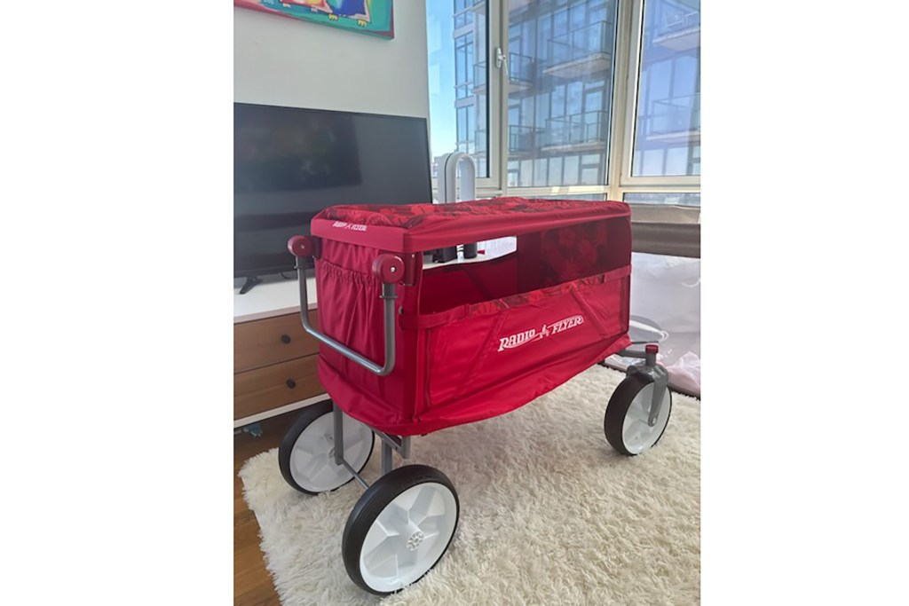 A red baby stroller in a room