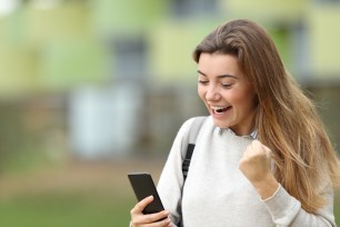 A college-age student celebrates getting a loan.