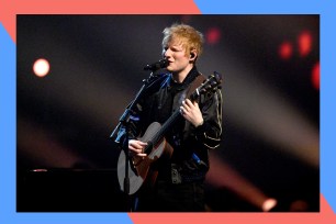 Ed Sheeran sings onstage with a guitar in hand.